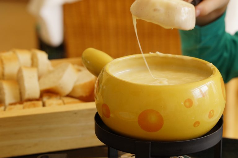 The Swiss Fondue of Melted Cheese, One of The Most Popular and Traditional Food in Europe