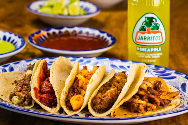 A mixed taco plate served with an all-natural-flavored Jarritos Pineapple Mexican Soda by Jarritos Mexican Soda via Unsplash